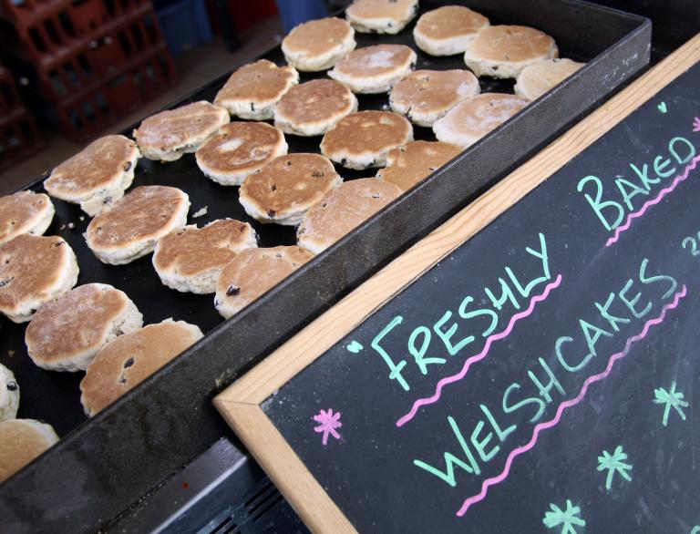 welsh cakes on griddle and sign.