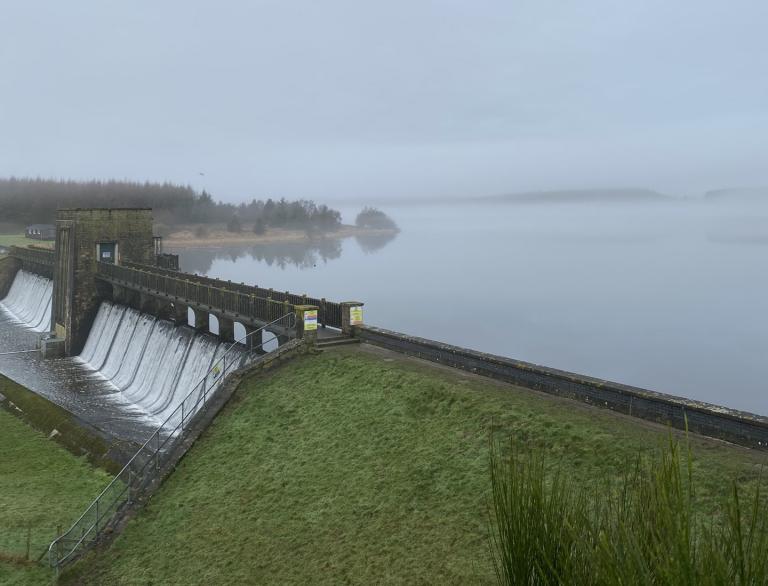 A dam and reservoir on a dull day.