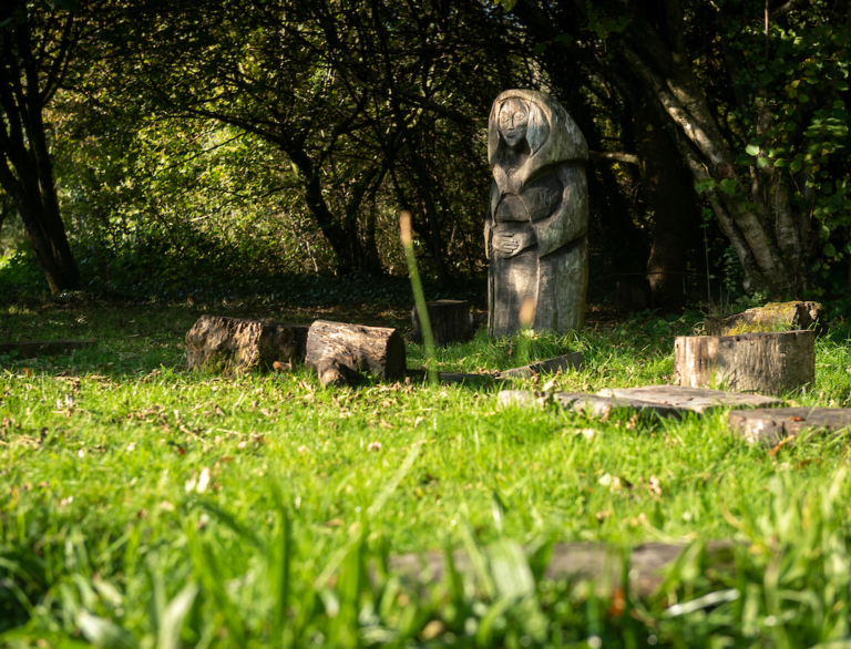 Wooden statues surrounded by a forest