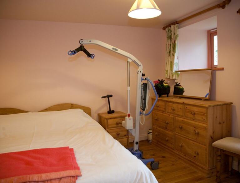 Accessible bedroom with mobile hoist.