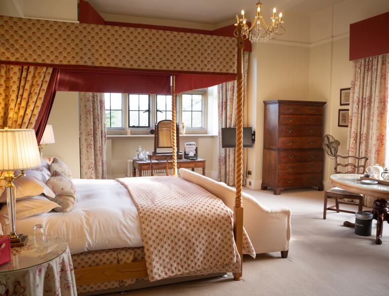Deluxe hotel bedroom with four poster bed.