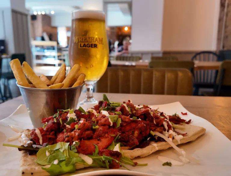 food and glass of Wrexham lager on table in restaurant.