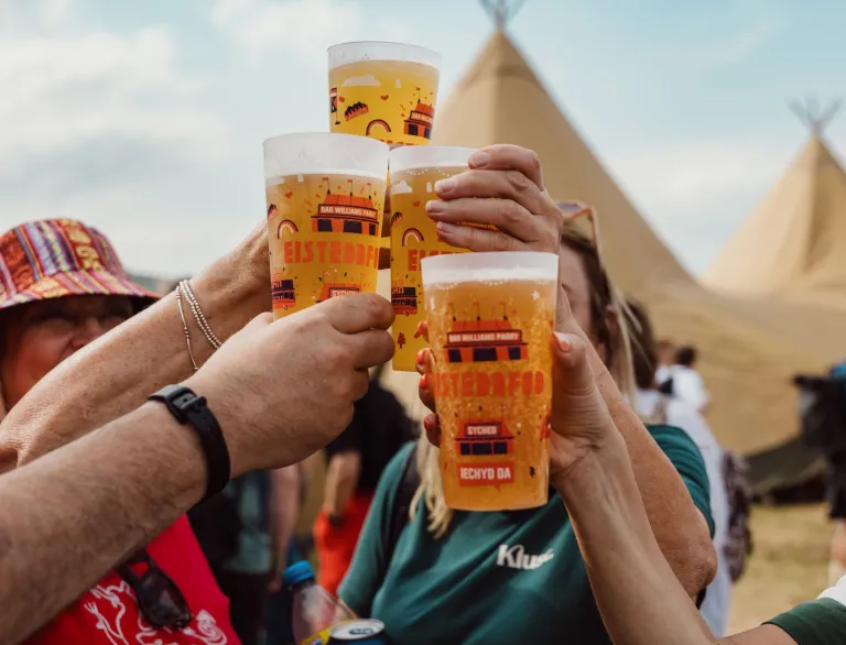 people tapping their Eisteddfod glasses together.