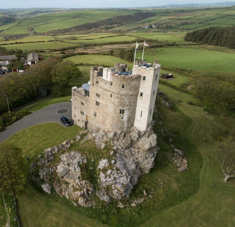An aerial shot of Roch Castle set amongst the rolling hills and valleys.