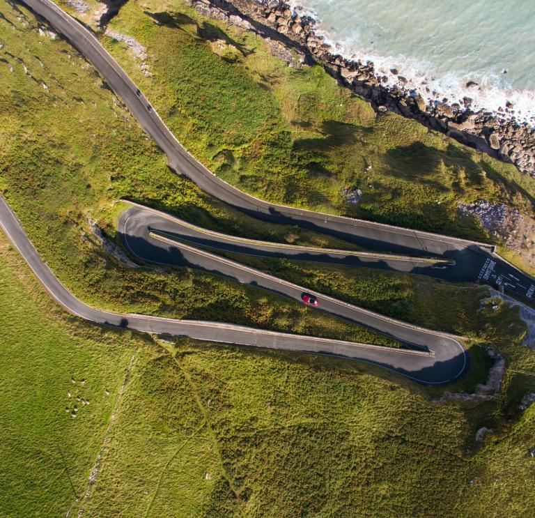 A car driving along a zig zag road on The Great Orme.
