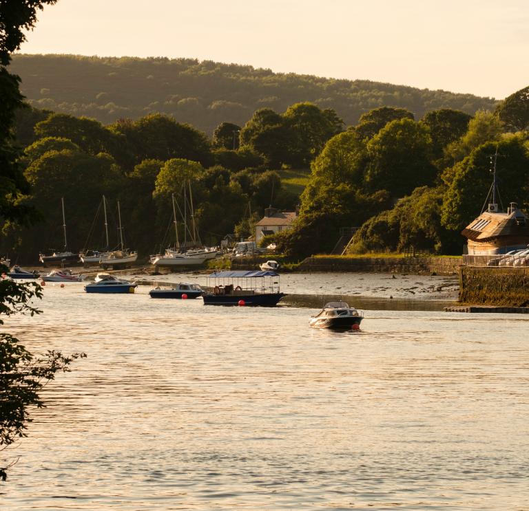 River Teifi in low light with boats on the river near a harbour..