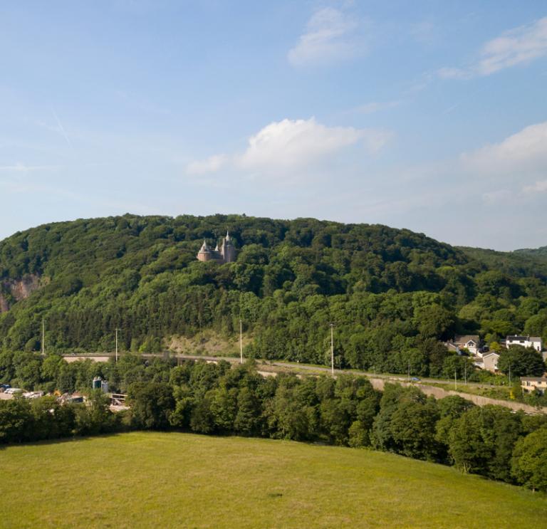 Landscape view with Castell Coch in the woods on the hill.