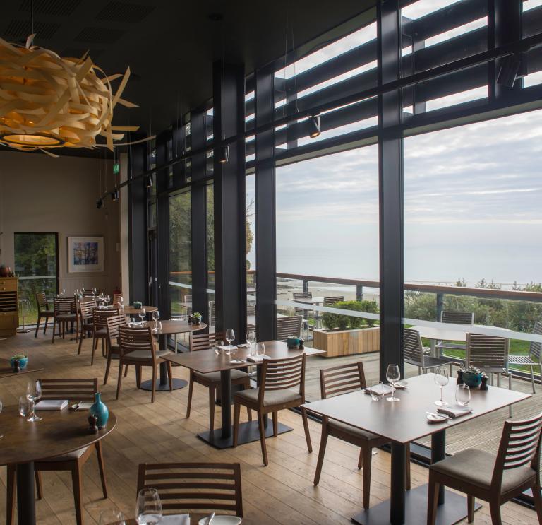 The dining room at Coast Restaurant, Saundersfoot with views of the ocean.
