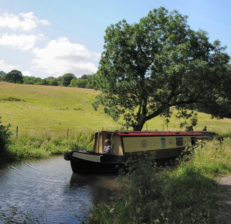 Canal boat on water at Monmouthshire &  Brecon Canal.