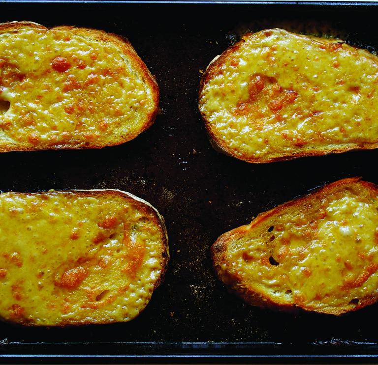 Slices of Welsh rarebit on a tray.