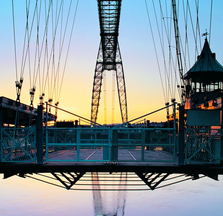 A large metal bridge at sunset.
