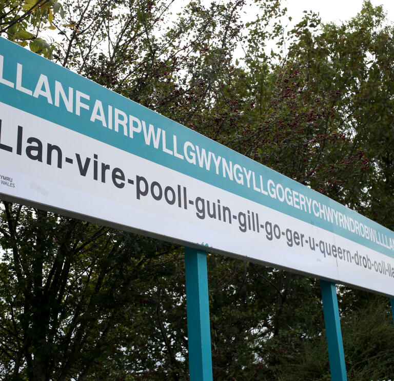 Llanfair PG sign at railway station, with name in full.