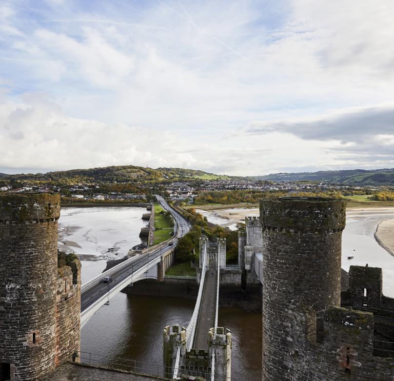 A road bridge and a railway bridge through castle towers.