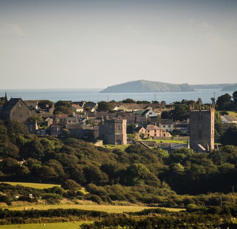 view of St Davids countryside, with cathedral and blue sea in the background.