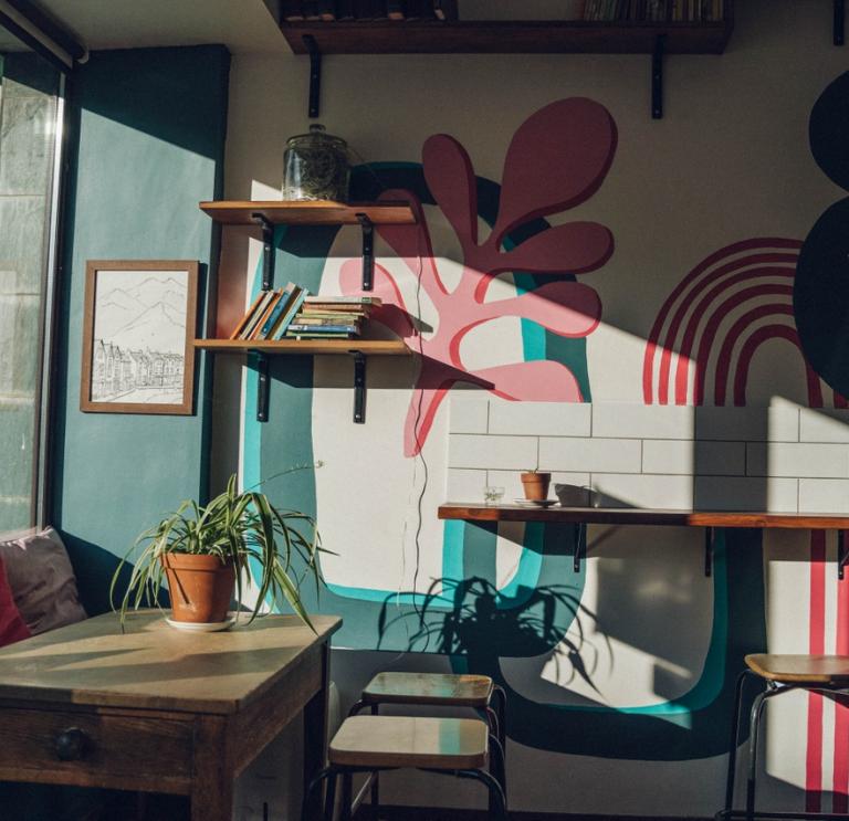 Inside a café with pink and blue design on the wall