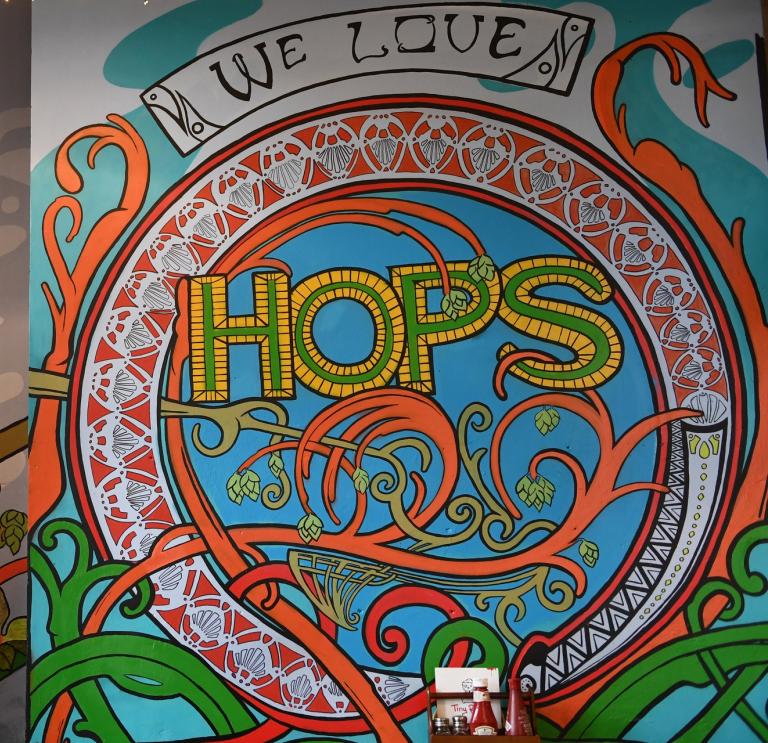 Colourful mural with 'We love hops' text.