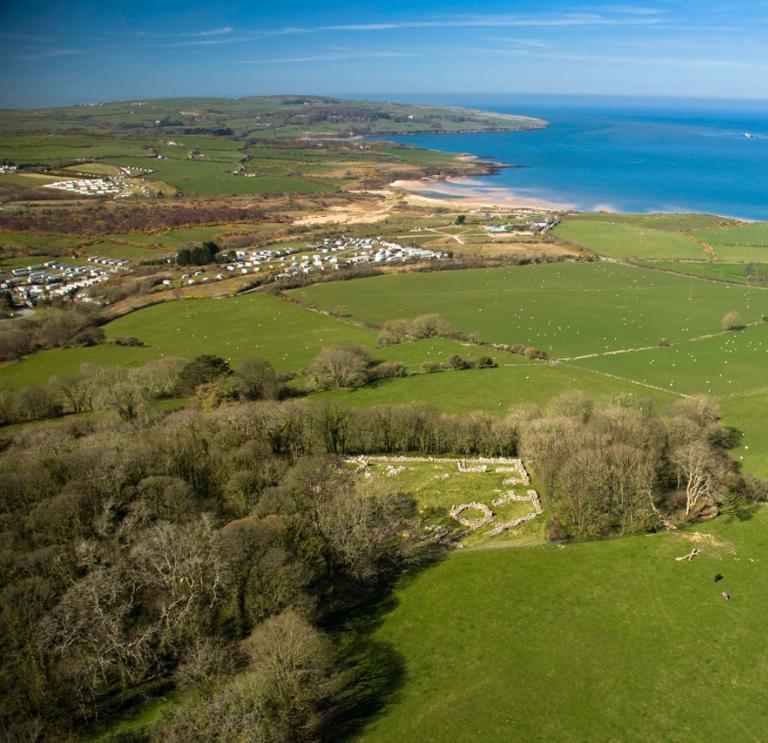 Ariel view of a campsite, surrounding fields and the coastline of Anglesey, North Wales.
