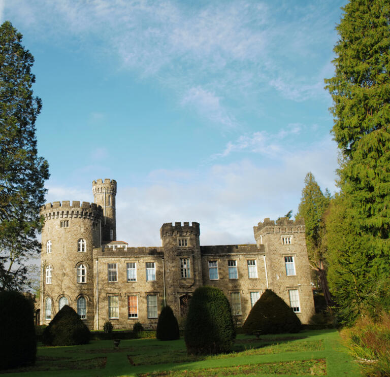A castle-style building with towers and many windows.