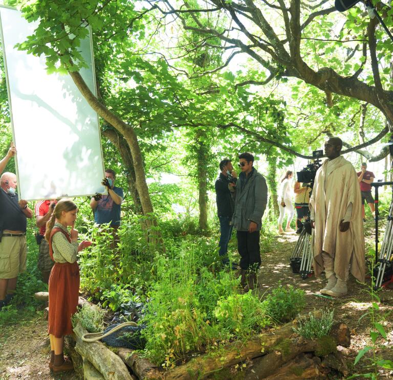 Film crew filming in woodland