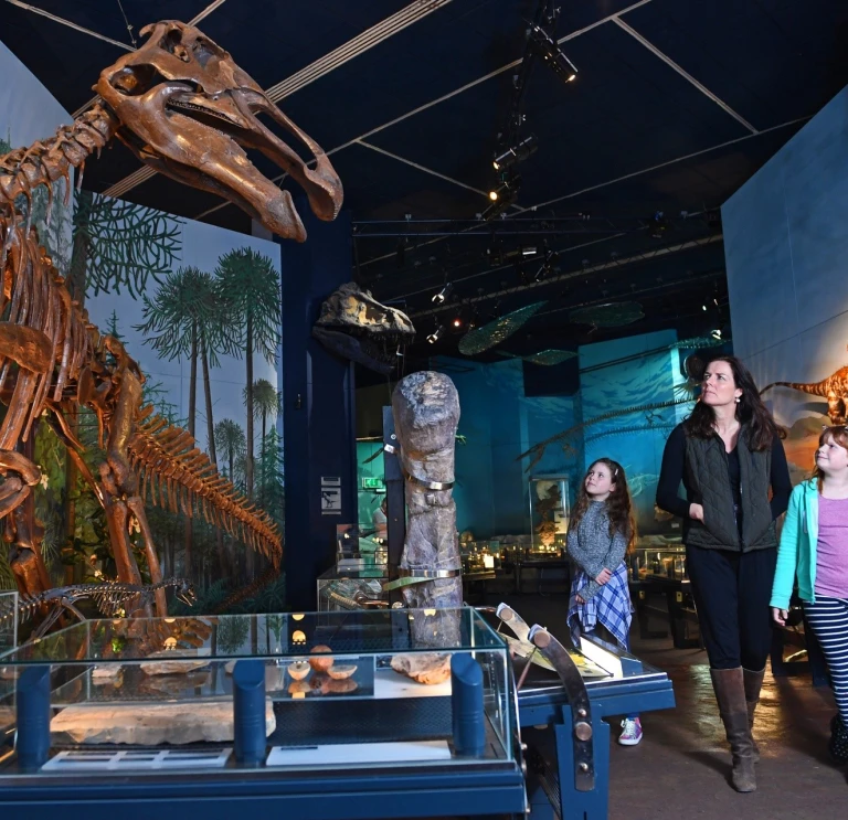 Family enjoying dinosaur exhibition at National Museum Cardiff