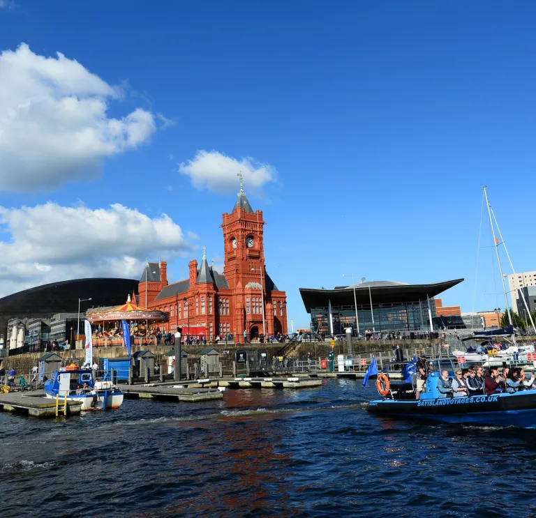A waterside view of Cardiff's bay area, with boat.