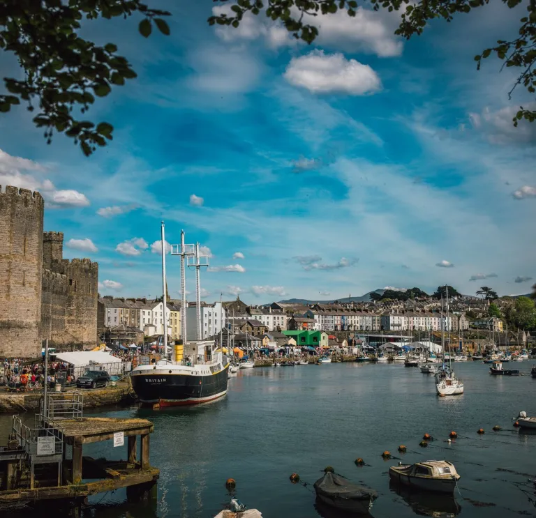 A pretty town with a castle, a quay with boats and old houses, and a food festival on.