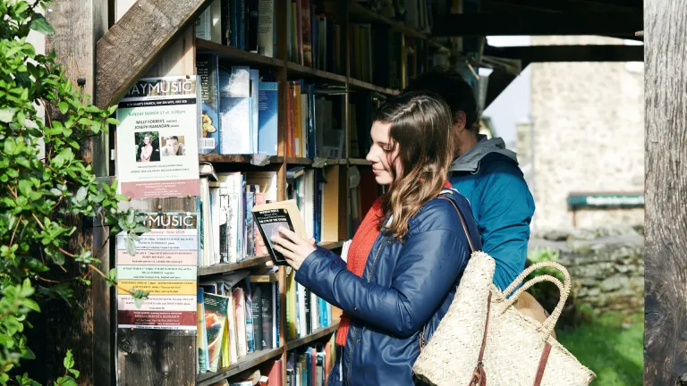 A lady looking at books in Hay-on-Wye.