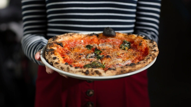 Freshly cooked crispy pizza on a plate.