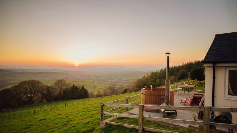 Sunset view across the Usk valley with hot tub and cottage in the foreground