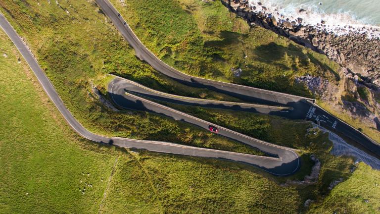 A car driving along a zig zag road on The Great Orme.