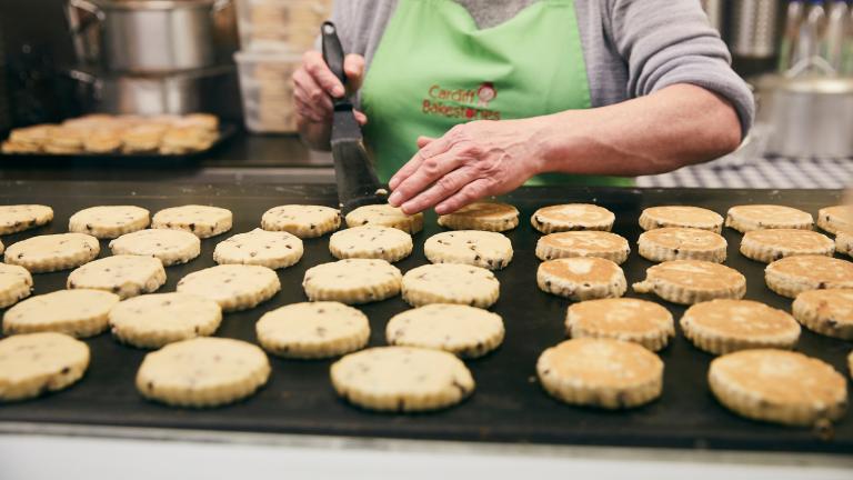 Woman cooking Welsh cakes.