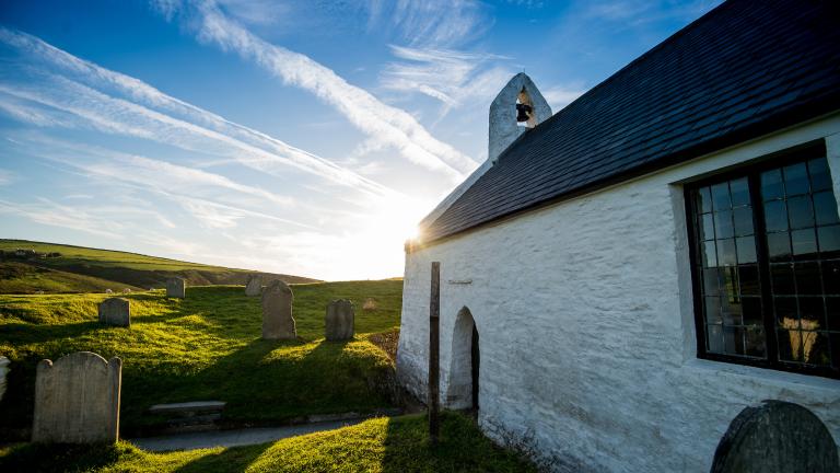 Sunny image of the side of a small whitewashed church