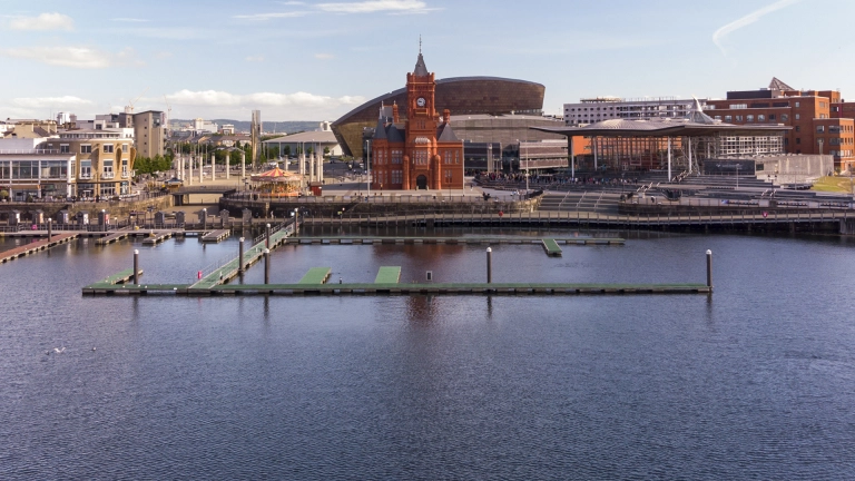 Landscape of the attractions at Cardiff Bay seen from the water.