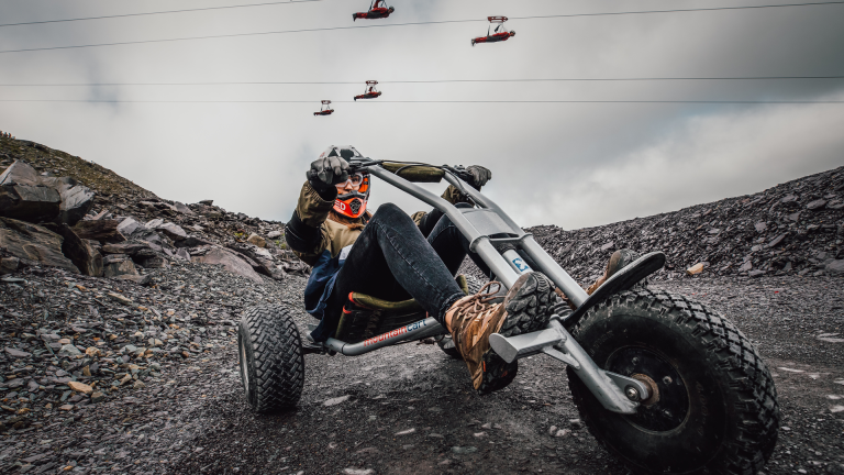 Quarry Kart at Zip World with people on the zip line above