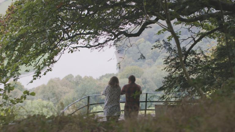 View of Nina and Joe Howden at The Eagle’s Nest, a viewpoint in the Wye Valley.