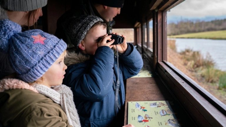 family bird watching in hide