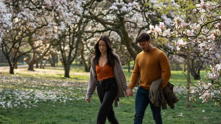 couple walking near blossoming trees in Bute Park, Cardiff