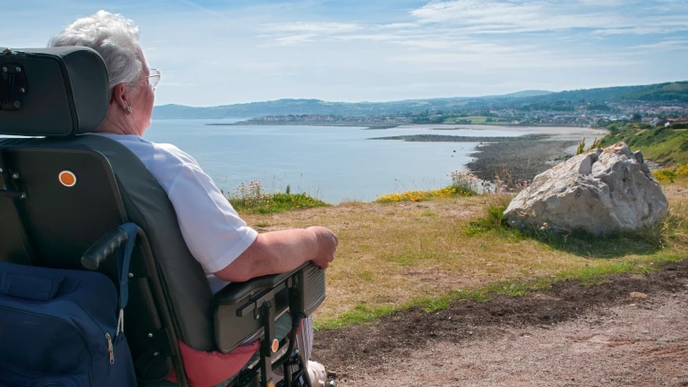 Female powerchair user on path near Little Orme.