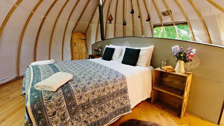 Double bed in a glamping dome.