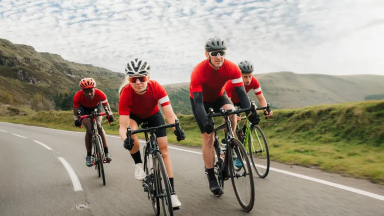 group of cyclists on mountain road.