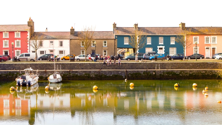 people sat on wall, Aberaeron harbour.