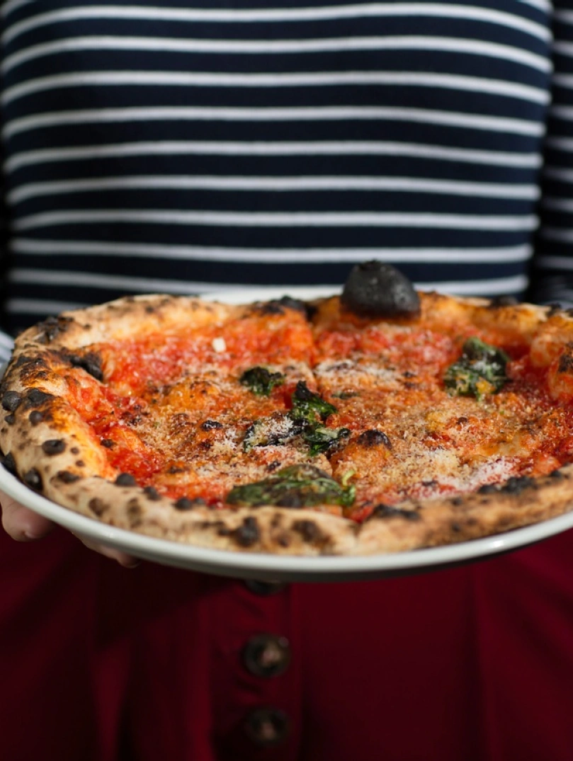 Freshly cooked crispy pizza on a plate.