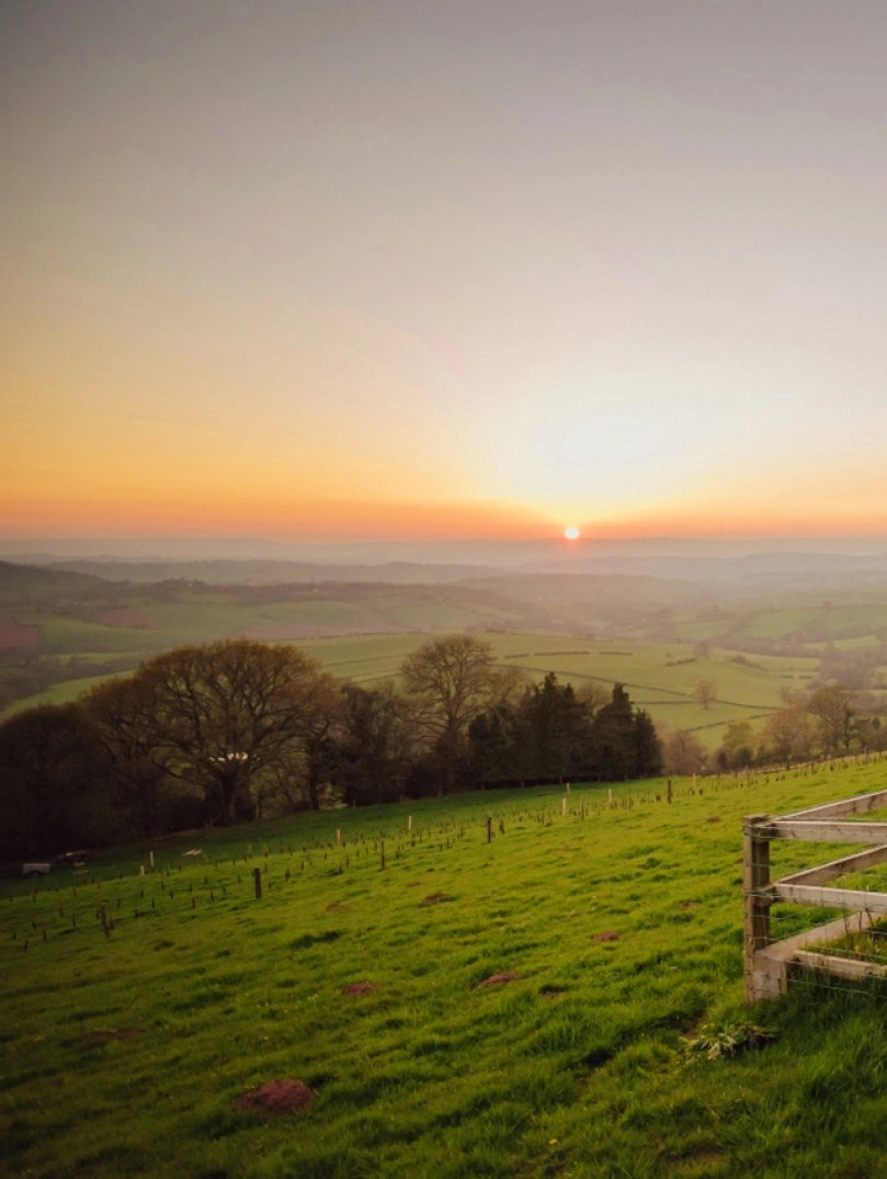 Sunset view across the Usk valley with hot tub and cottage in the foreground
