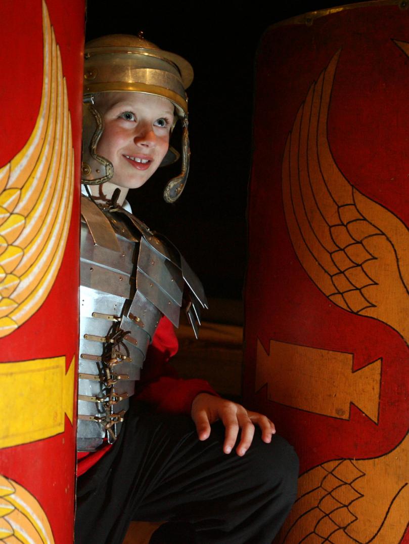 child dressed in Roman custom.