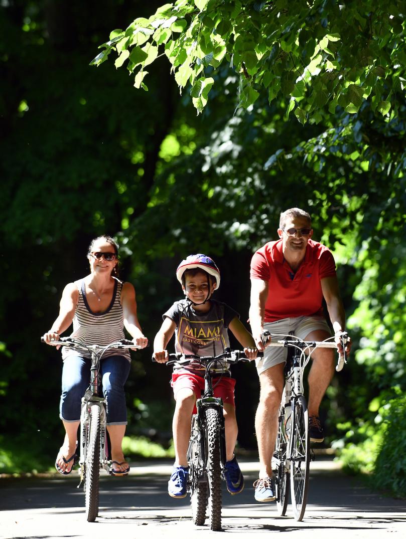 Family riding bikes along the Taff Trail, South Wales.