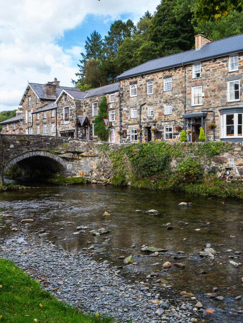 Stone houses and bridge in Beddgelert by the river.