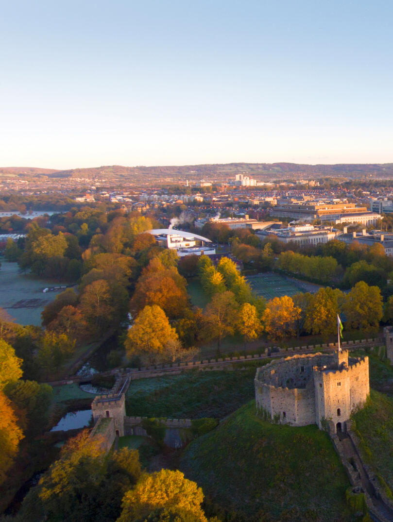 Aerial shot of Cardiff Castle with view of city.