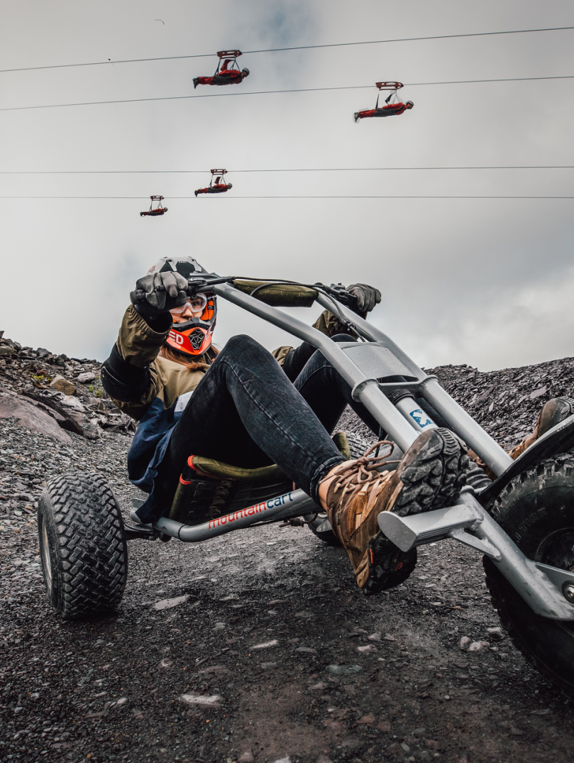 Quarry Kart at Zip World with people on the zip line above