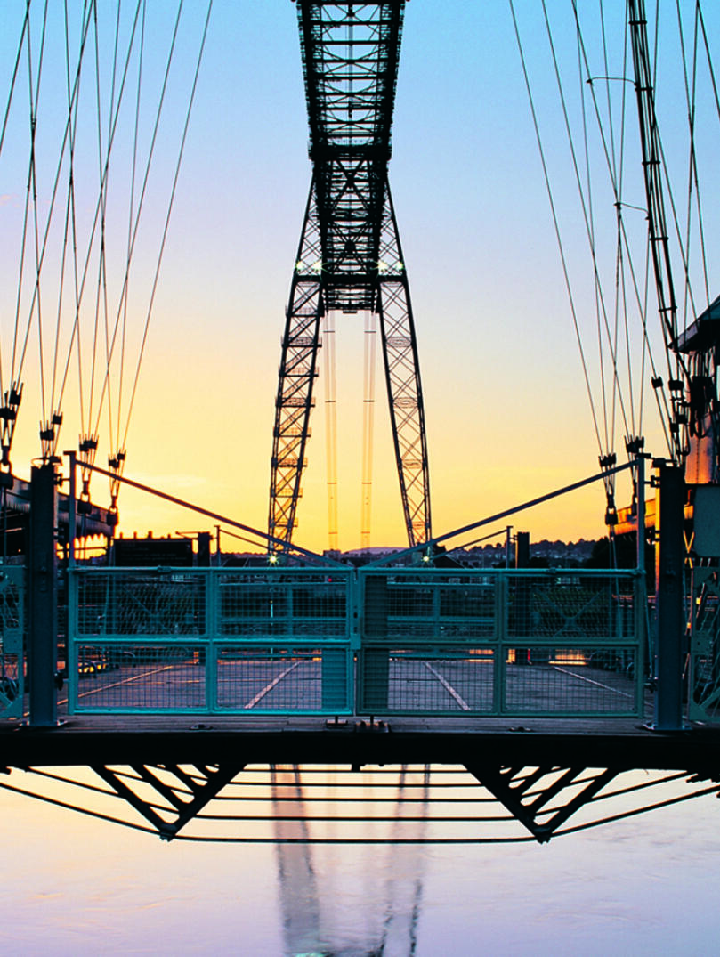 A large metal bridge at sunset.