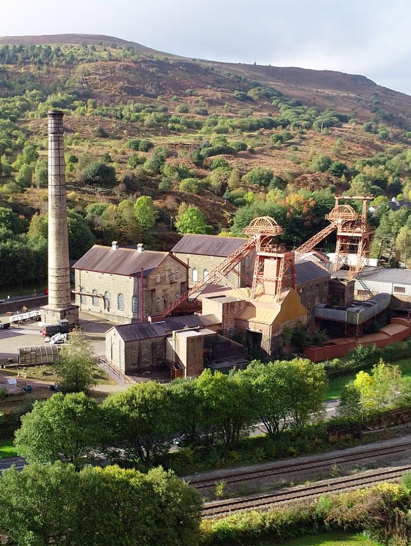 Distance view of Rhondda Heritage Park with hills in background.